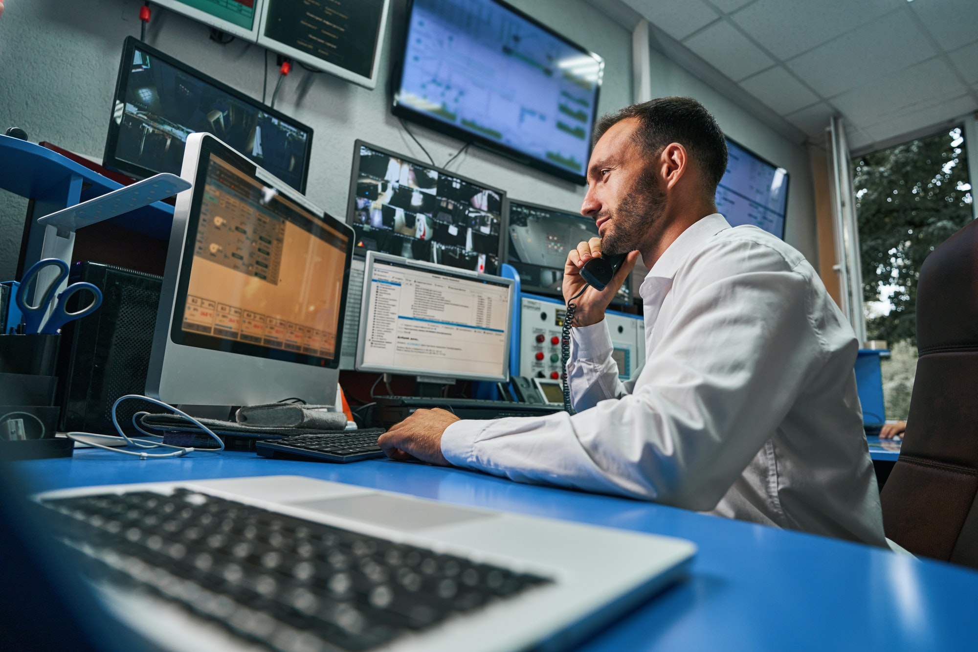 Security operator working at a monitoring desk