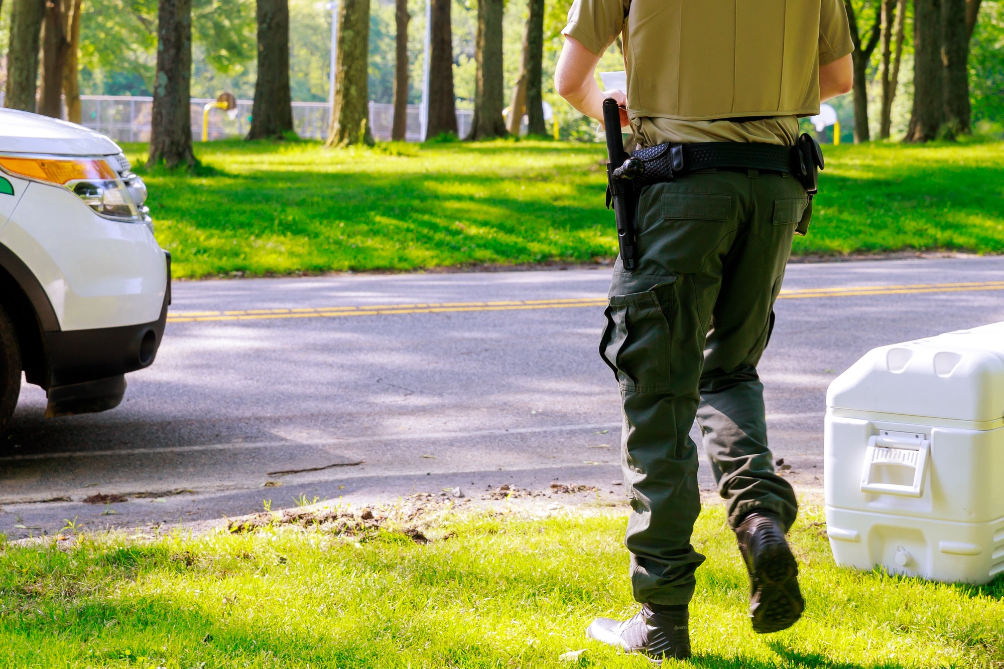 Security officer working alongside a guard patrolling a park